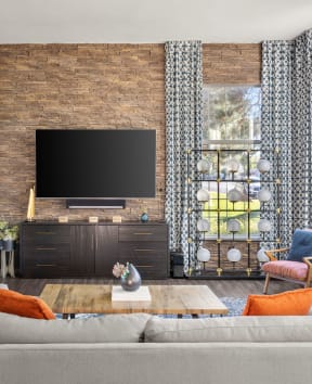 a living room filled with furniture and a large flat screen tv
